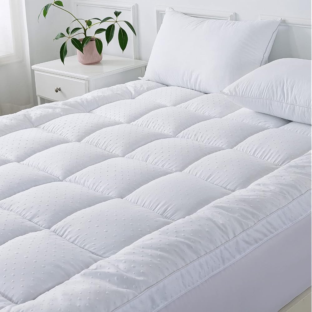Close view of quilted pillow-top mattress topper on a bed