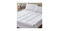 White quilted pillow-top mattress topper on a bed in a styled bedroom