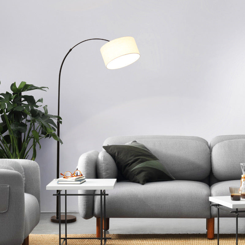 Black arc floor lamp beside sofa