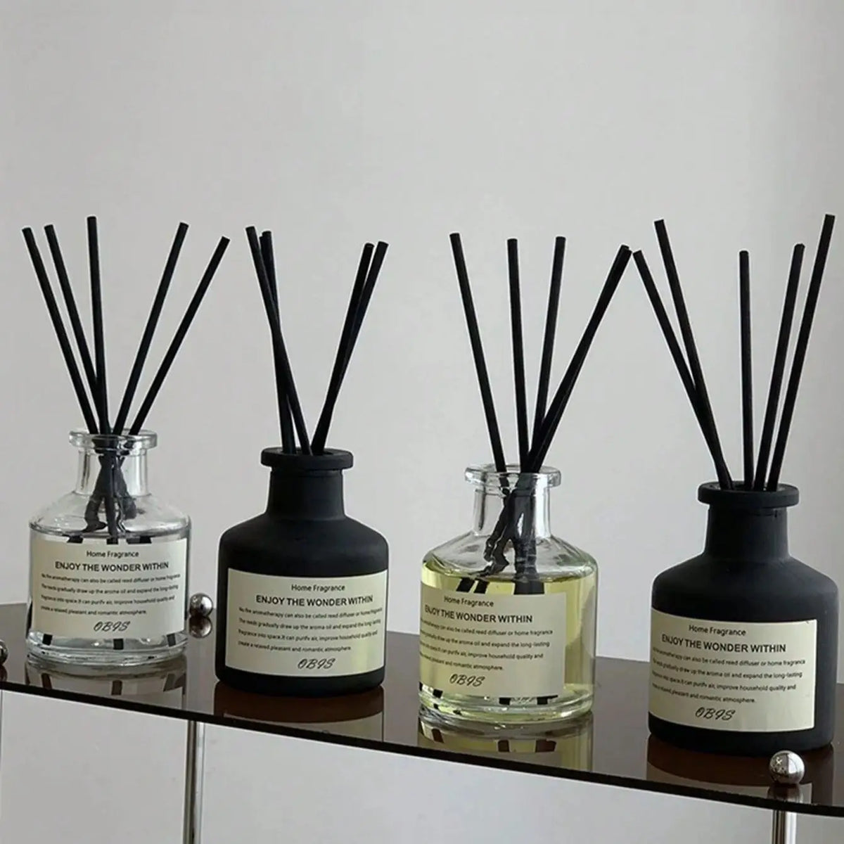 Reed diffuser with rattan sticks in glass bottle