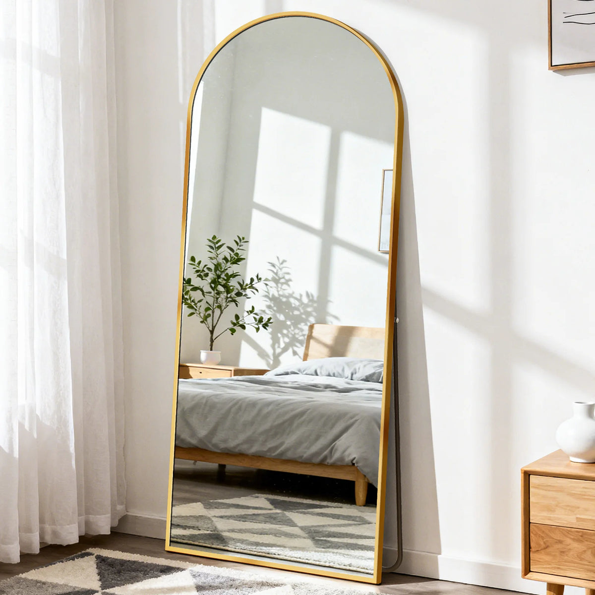 Arched full-length floor mirror with gold frame