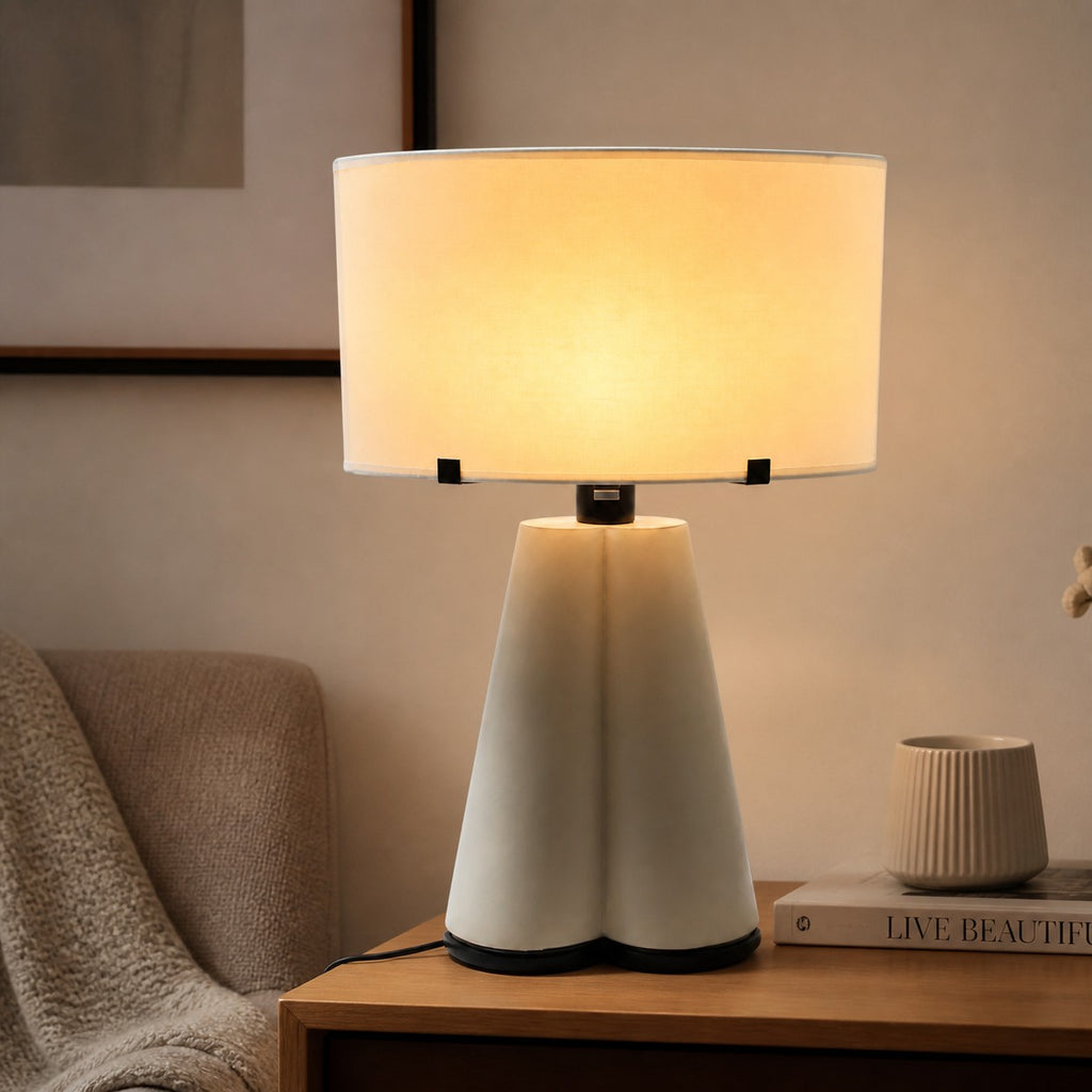 Tapered drum lamp shade turned on, styled room